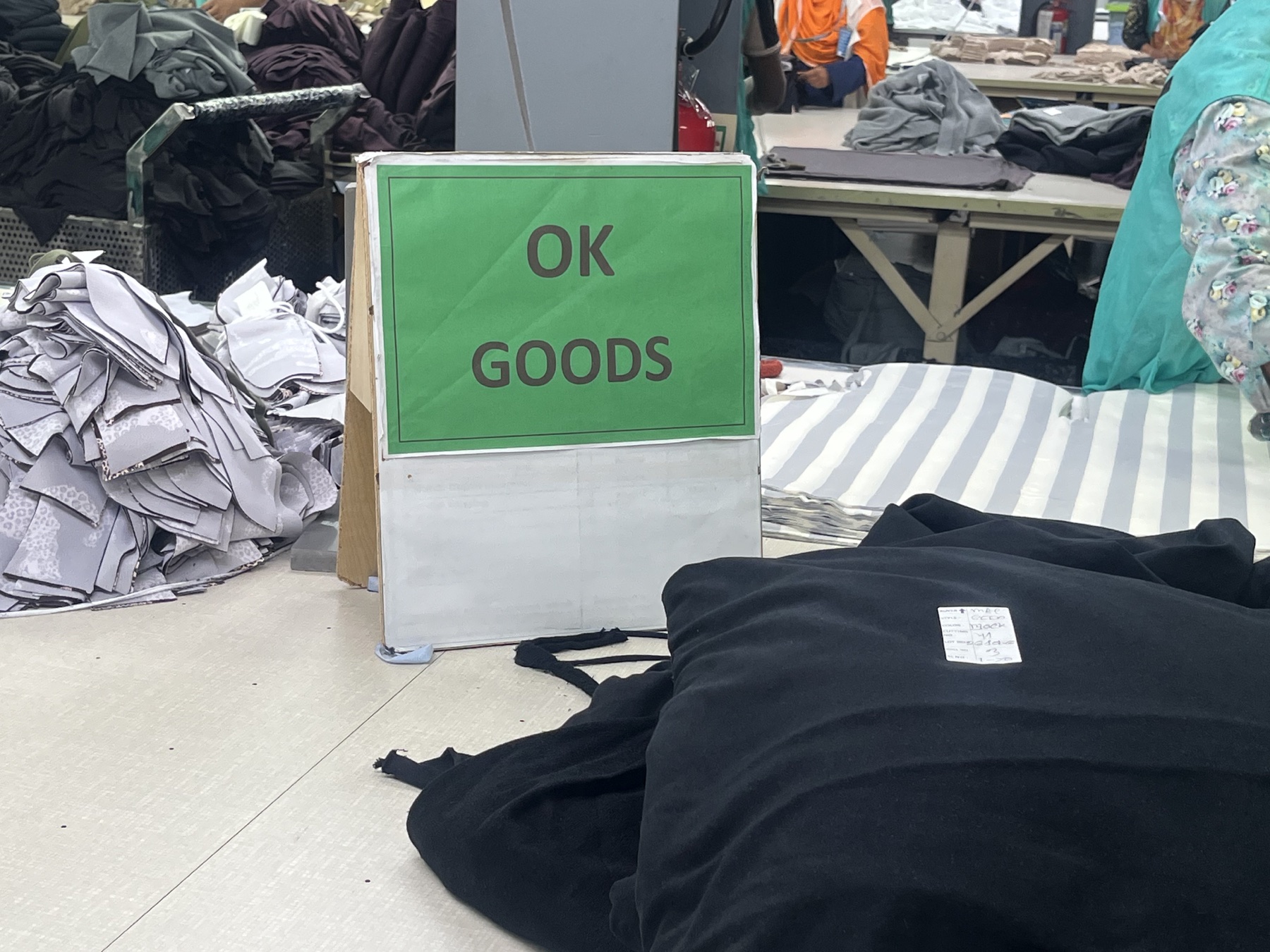 Manually approved garment panels waiting at an OK Goods sorting station